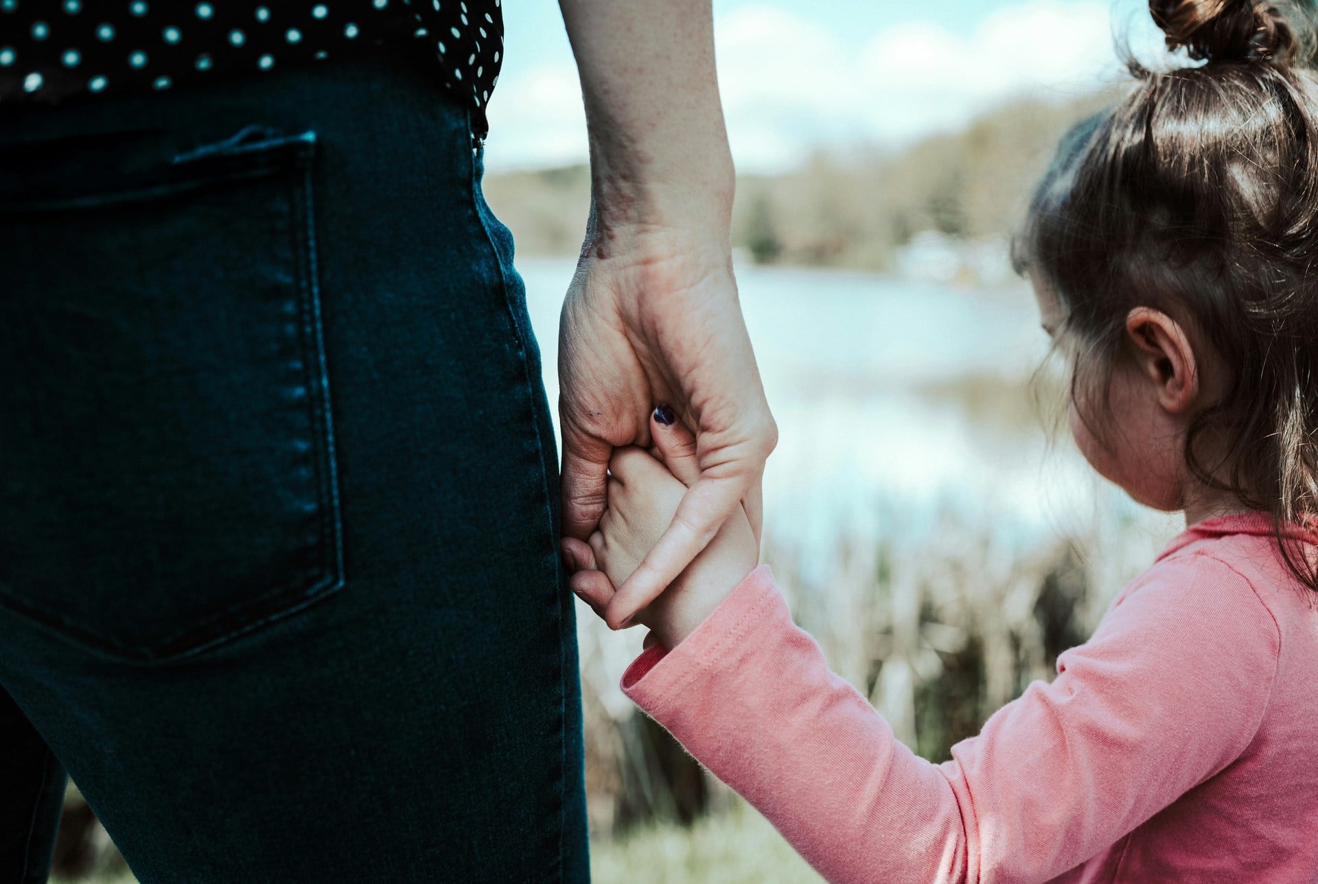 mother holding daughters hand